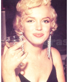Marilyn Monroe drinking champagne (1955 from ThisIsMarilyn.com)