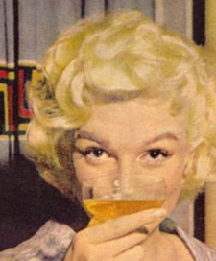 Marilyn Monroe drinking champagne close-up (1955 from ThisIsMarilyn.com)
